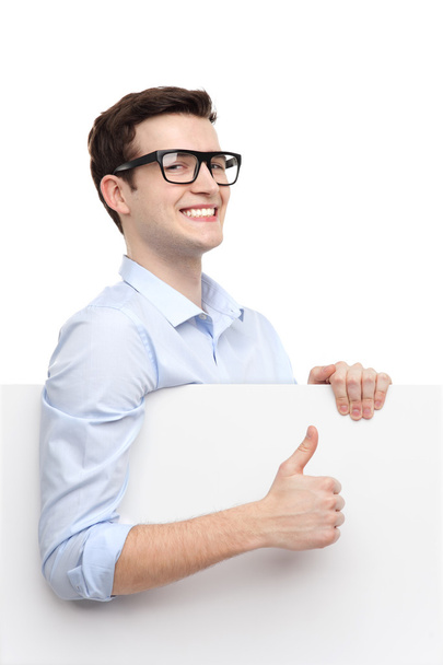 Man with blank poster showing thumbs up - Foto, Imagen