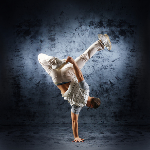 A young and fit dancer in modern clothes performing - Foto, imagen