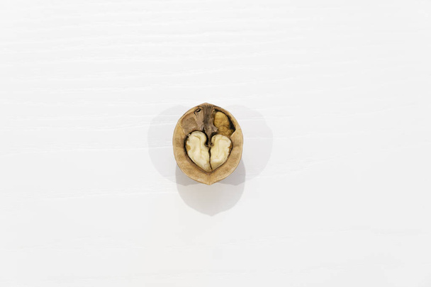 open heart shaped walnut on white background - Valokuva, kuva