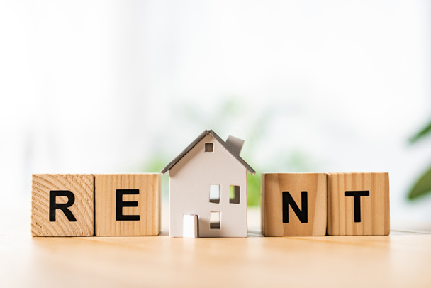 house model near wooden cubes with rent lettering on table - Photo, Image
