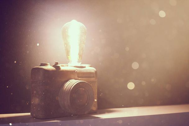 A vintage lamp made as an old film camera on cement background - Photo, Image