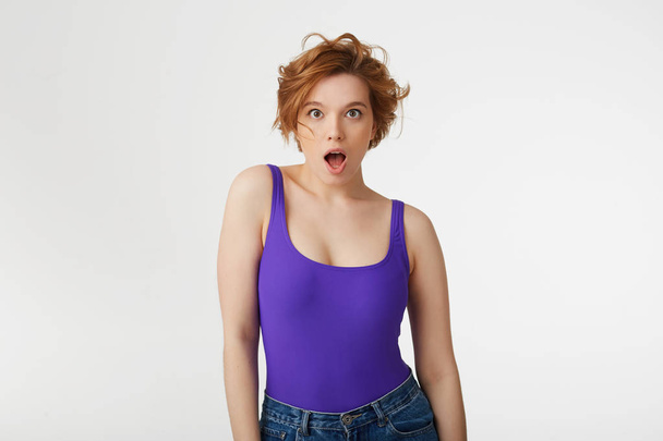 Young surprised attractive short-haired girl, wearing a purple j - Photo, Image