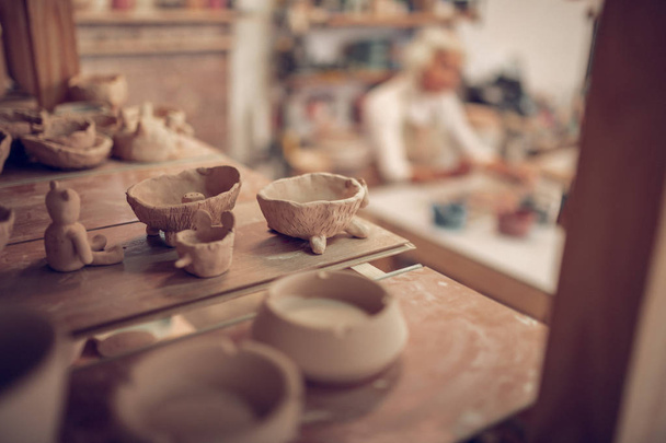 Close up of clay bowls standing on the shelf - Fotó, kép