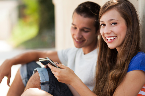 Teenage couple smiling - Фото, изображение