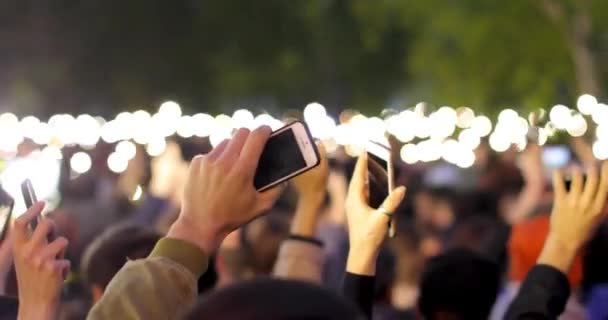 A blurred view of many bright smartphone flashlights filling - Footage, Video