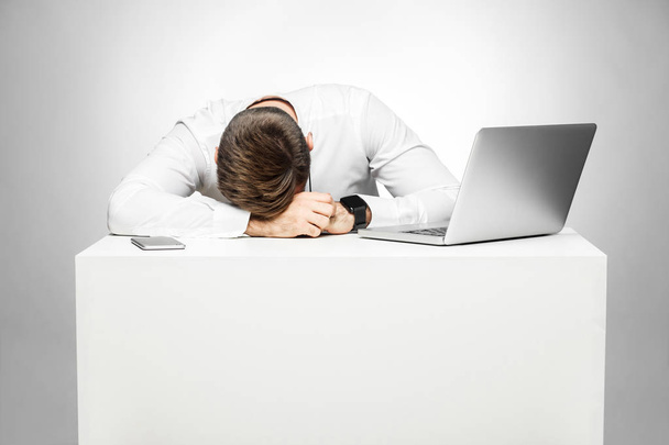 sleepy tired freelancer in white shirt snoozing at work place near laptop - Photo, Image
