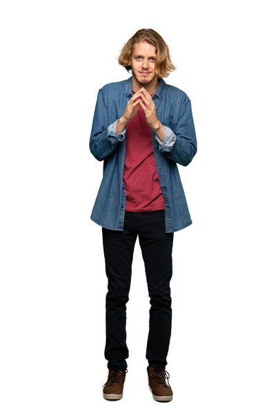 Full-length shot of Blonde man scheming something over isolated white background - Foto, afbeelding