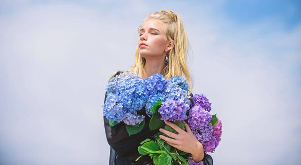 Flowers tender fragrance. Fashion and beauty industry. Girl tender fashion model hold hydrangea flowers bouquet. Makeup and fashion style. Fashion trend spring. Meet spring with new perfume fragrance - Photo, Image