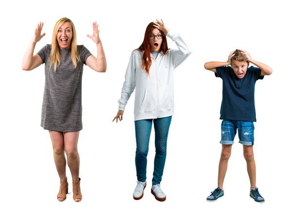 Group of Kid, young girl and Middle age blonde woman with grey dress with surprise and shocked facial expression. Mouth open because not expect what has happened - Photo, Image