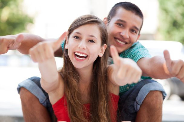 Teenage couple with thumbs up - Photo, Image