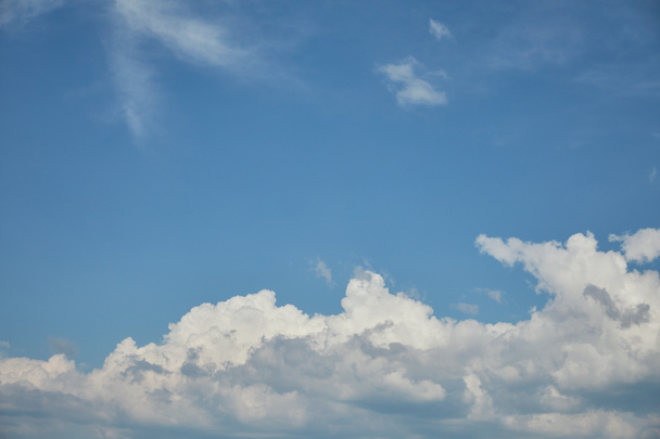 White clouds on bright blue sky with copy space - Foto, afbeelding