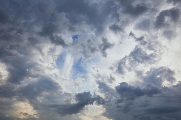 dark clouds on blue sky background with copy space - Fotó, kép