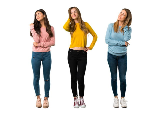 A full-length shot of a group of people with colorful clothes thinking an idea while scratching head on isolated white background on isolated white background - Foto, afbeelding