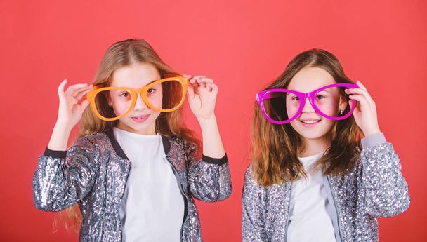 Girls funny big eyeglasses cheerful smile. Birthday party. Happy childhood. Sincere cheerful kids share happiness and love. Joyful and cheerful. Sisterhood concept. Friendly relations siblings - Foto, Bild