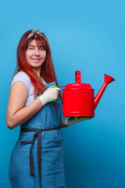 Photo of cheerful florist brunette woman with watering can in hand - Zdjęcie, obraz
