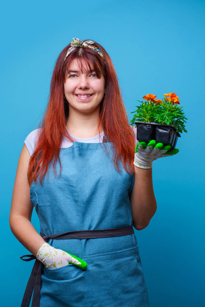 Photo of happy brunette girl with marigolds in her hands - Foto, Imagen