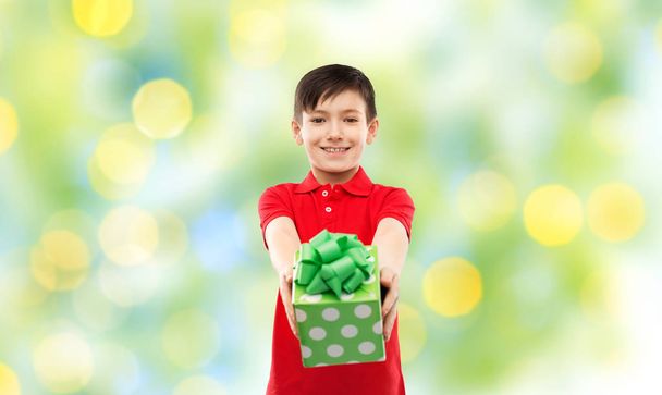 smiling boy in red t-shirt with birthday gift box - 写真・画像