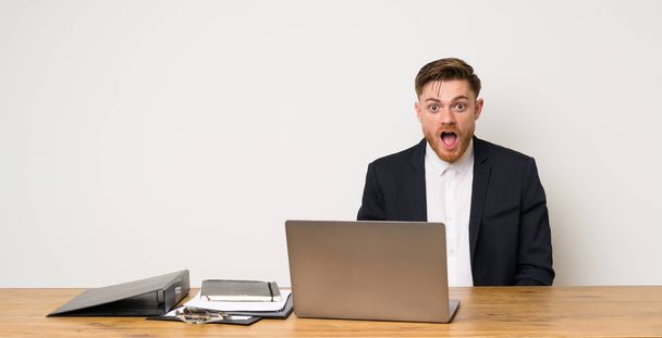 Businessman in a office with surprise facial expression - Valokuva, kuva