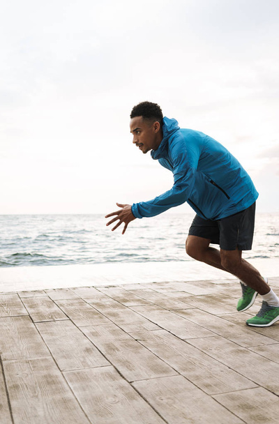 Young african sports man runner outdoors at the beach sea running make exercises. - Φωτογραφία, εικόνα