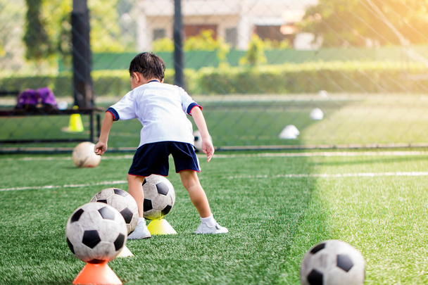 id soccer player is start training to shoot ball on marker cone  - Фото, зображення