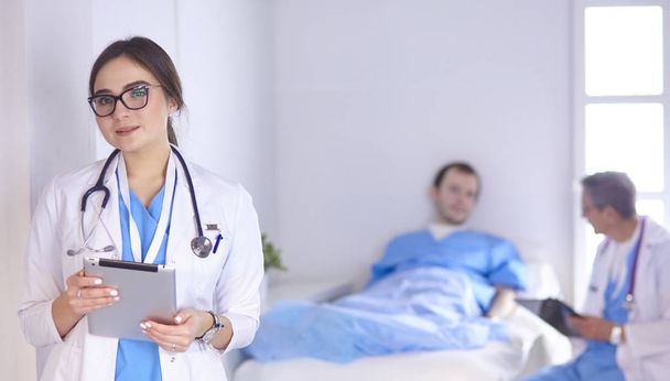 Doctor checking heart beat of patient in bed with stethoscope - Photo, Image