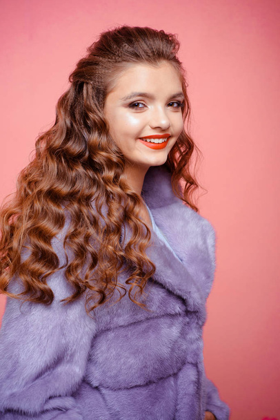 Giving her hair moisture and bounce. Young woman with long locks of hair. Teenage girl with stylish wavy hairstyle. Pretty girl with curly hairstyle. Healthy hair care. Hair styling in beauty salon - 写真・画像
