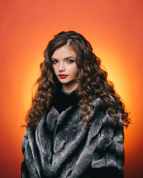 Her wavy hair flow over shoulders. Cute girl with curly hairstyle. Teenage girl with stylish wavy hairstyle. Young woman with long locks of hair. Healthy hair care habit. Hair styling in beauty salon - Zdjęcie, obraz