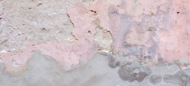 Old weathered painted wall background texture. White grey pink dirty peeled plaster wall with falling off flakes of paint - Photo, Image