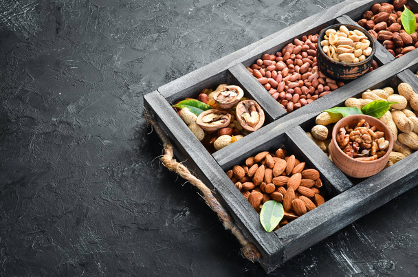 Set nuts and dried fruit in a wooden box. Top view. Free space for your text. - Photo, Image