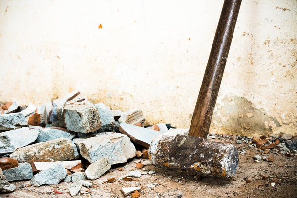 A hammer used to demolish the concrete tile floor and wall of the house before renovation. It heavy and very hard because it made from metal. - Фото, изображение