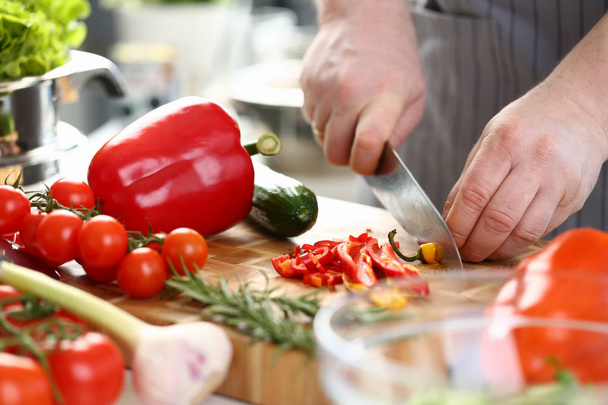 Professional Culinary Man Cutting Hot Chili Pepper - Photo, image