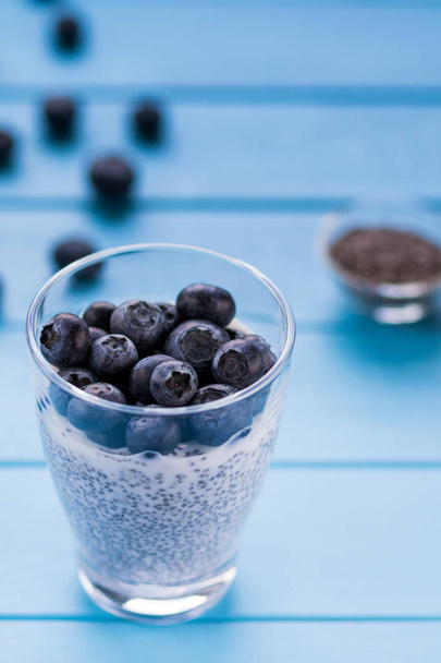 Freshly picked blueberries in milk yogurt with chia seeds - Foto, imagen