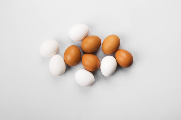 Group of raw eggs white and brown. Concept of diversity, isolati - Photo, Image