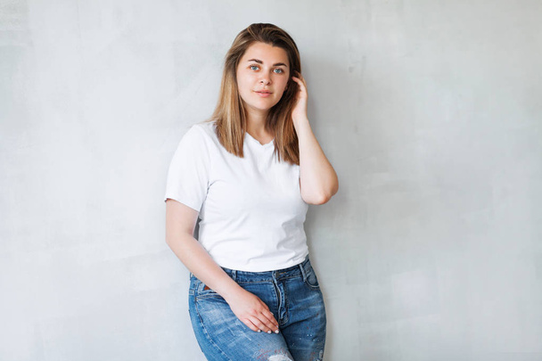 Young beautiful woman in white t-shirt and jeans  - Fotó, kép