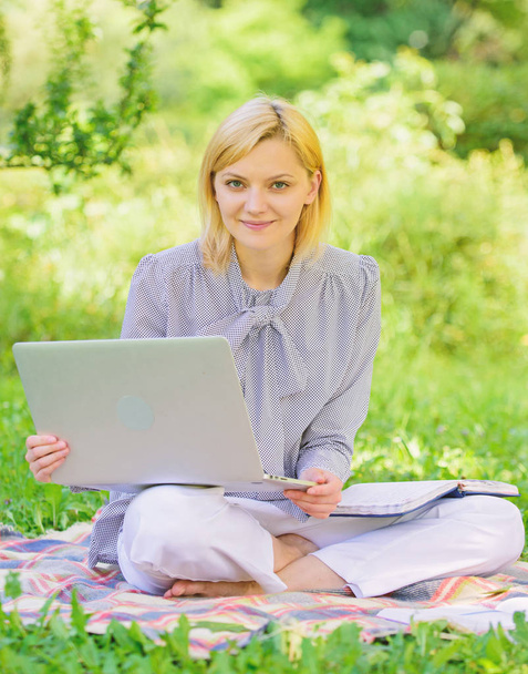 Business lady freelance work outdoors. Become successful freelancer. Woman with laptop sit on rug grass meadow. Online freelance career concept. Guide starting freelance career. Pleasant occupation - Фото, зображення