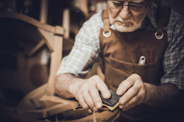 Elderly carpenter with glasses portrait - 写真・画像