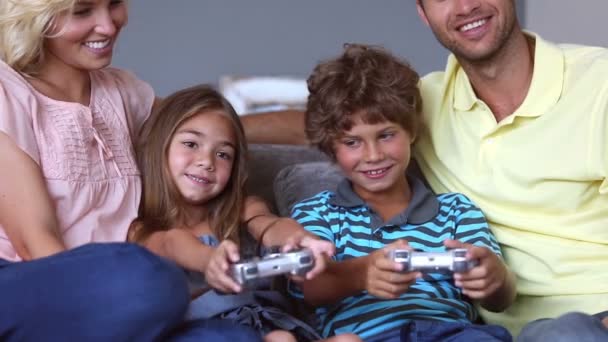 Parents watching chidren playing video games - Materiaali, video