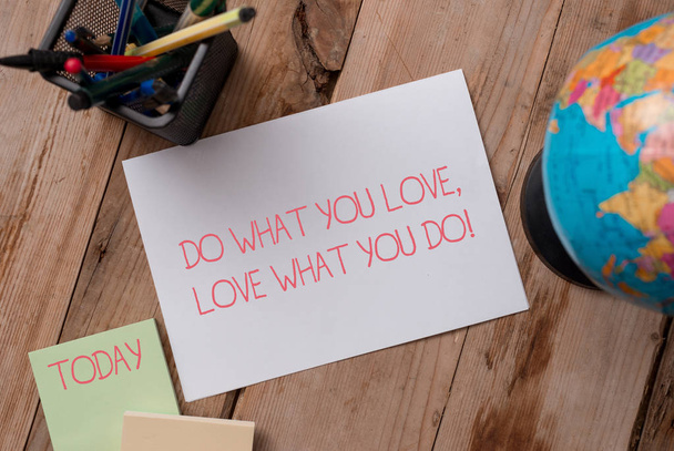 Writing note showing Do What You Love Love What You Do. Business photo showcasing you able doing stuff you enjoy it to work in better places then Writing equipments and sheets with artificial globe on - Photo, Image
