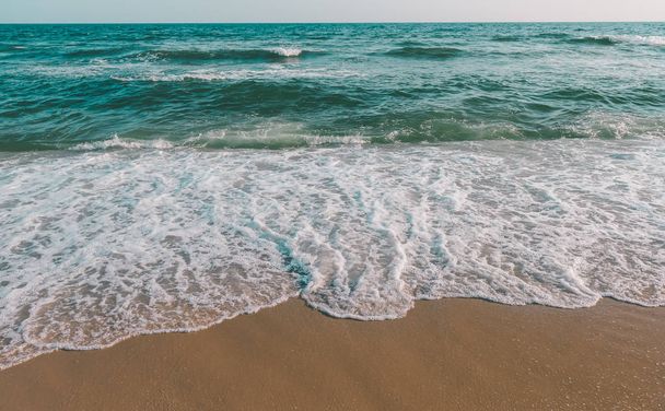 Sea wave and brown sand beach in grey tone. - Фото, зображення