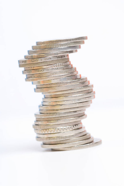 Coins stacked on each other in different positions on white back - Foto, Imagem