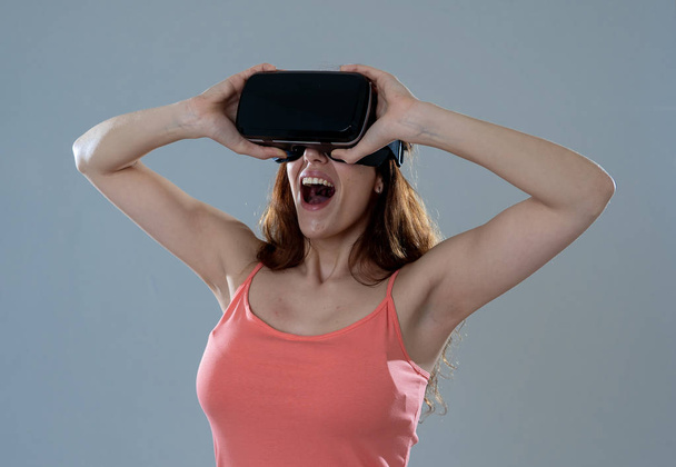 Amazed woman getting experience using VR headset glasses, feeling excited about simulation, exploring virtual reality making gestures interacting with new virtual world. In new technology concept. - Fotografie, Obrázek