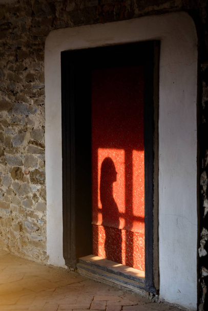 Sziluettje egy lány előtt az ablakon a régi szobában. - Fotó, kép