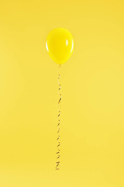 Bright balloon on color background. Celebration time - Foto, imagen