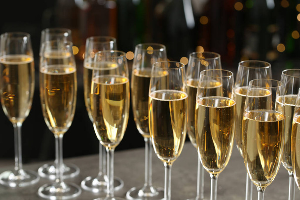 Many glasses of champagne on blurred background, closeup - Фото, изображение
