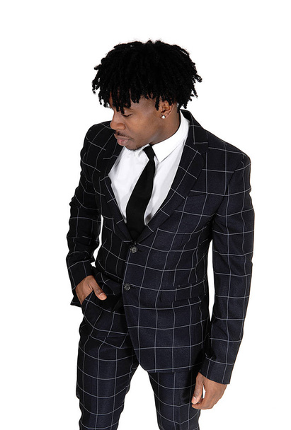 Black man in a dark suit standing in the studio with fussy black - Foto, Imagen