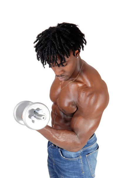 A black man working out with his dumbbells - Foto, imagen