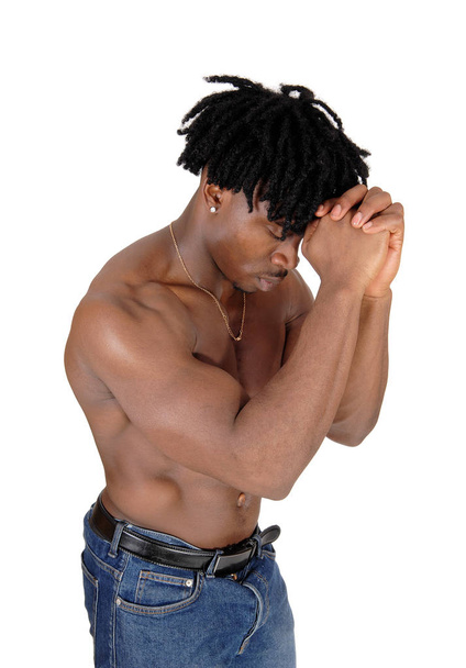 Close up of a black man flexing his muscles with his hands on fa - Φωτογραφία, εικόνα