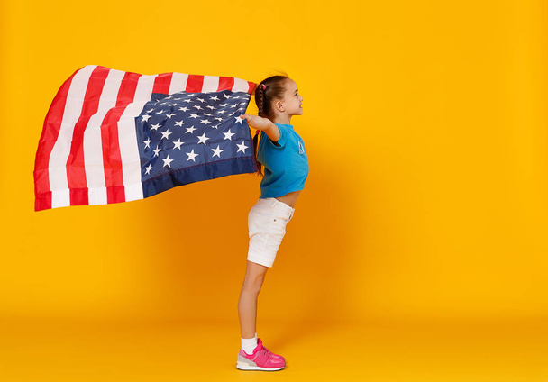 happy child girl with flag of   United States of America USA on  - Zdjęcie, obraz