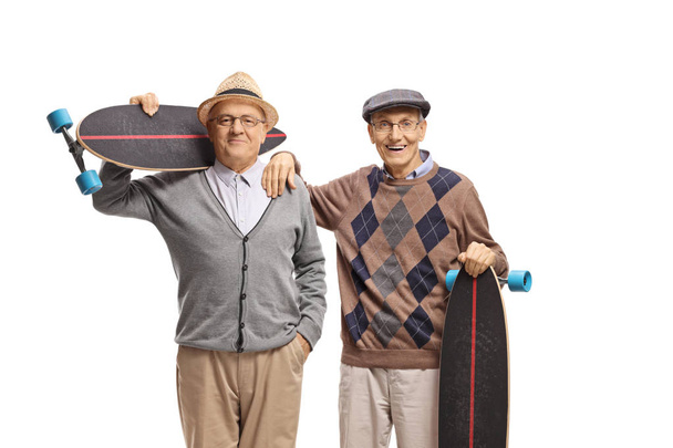 Two cheerful seniors with longboards isolated on white background - Zdjęcie, obraz