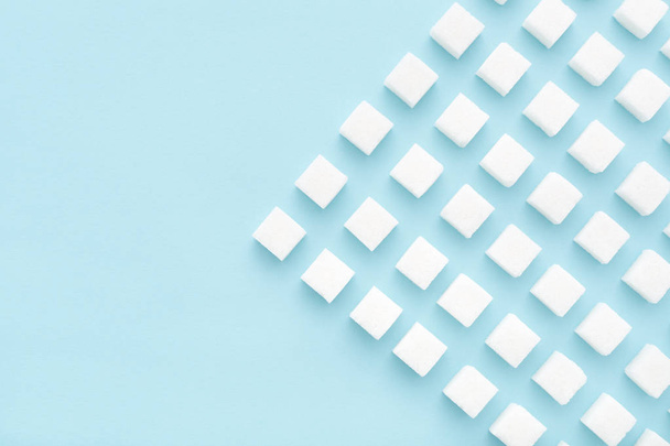 Sugar cubes pattern on blue background with copy space Top view - Foto, immagini